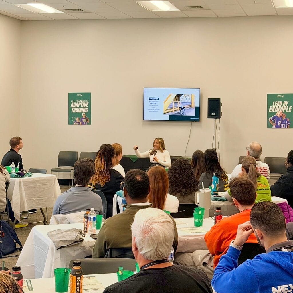 alycia speaking in a crowded room at the special olympics virginia fitness collaborative