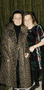 m e and wesley sanders dressed to the nines m e in a leopard skin trench coat and wesley in a shiny gown standing next to  each other