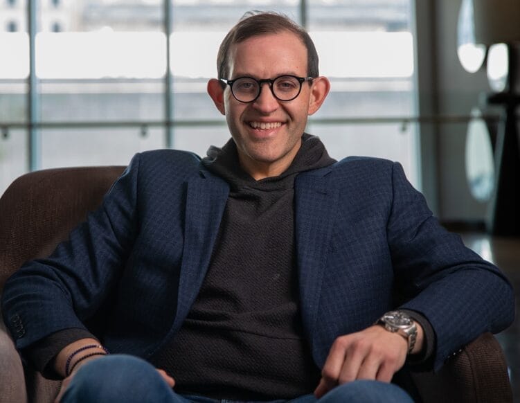 michael liner sitting in an armchair smiling