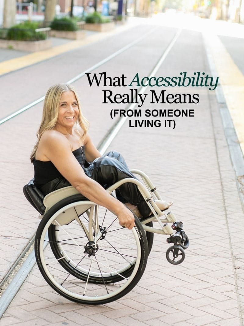 Alycia Anderson smiling in her wheelchair on a city street with rail tracks, with text reading, “What Accessibility Really Means.