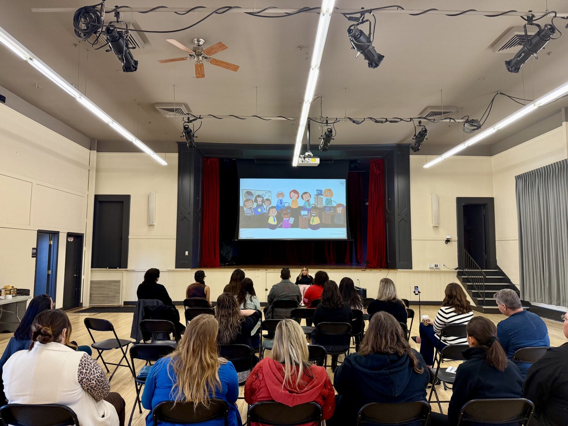 Alycia Anderson giving a keynote in front of a large group