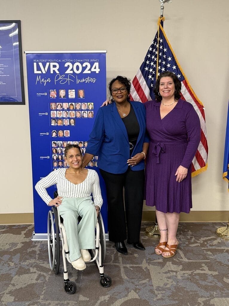 Alycia with Robin and Lorri after keynote in an group photo my American flag