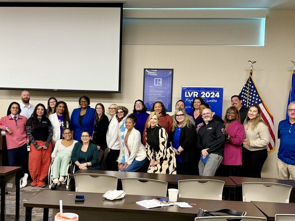 Alycia with large group after keynote event on disability inclusion in housing